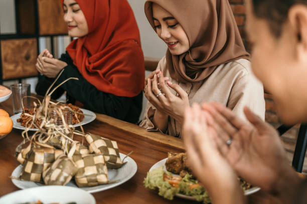 istock muslim people praying before break fasting 1148177682
