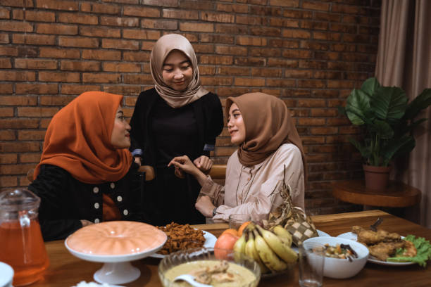 istock muslim woman talk to each other while dinner 1148177723