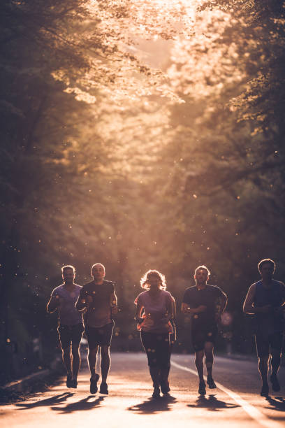 istock Group of runners taking a part in marathon race at sunset. 1148180430