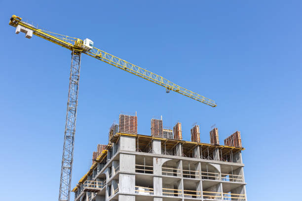istock building under construction with yellow crane on blue sky background 1148182254
