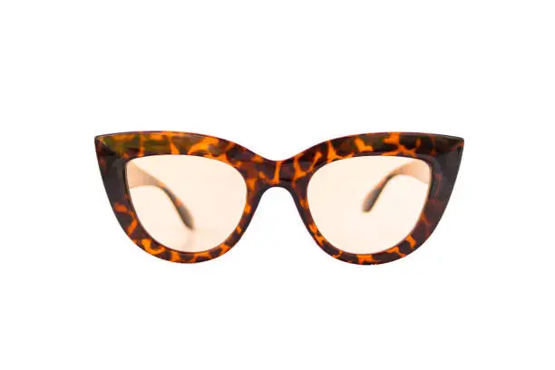 Cat eye shaped transparent sunglasses with leopard pattern thick frame at isolated white background, front view