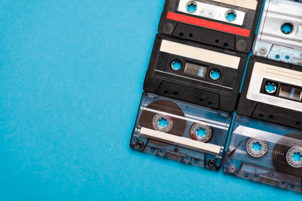 istock Retro cassette tapes places in blue background. 1148185930