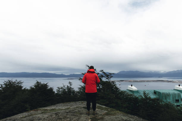 istock Man looking at mountains and Pacific Ocean in Ushuaia 1148185994