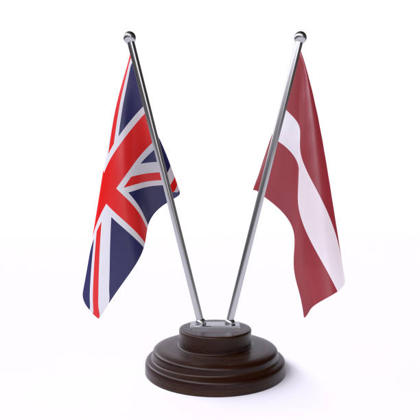 istock UK and Latvia, two table flags on white background 1148186080
