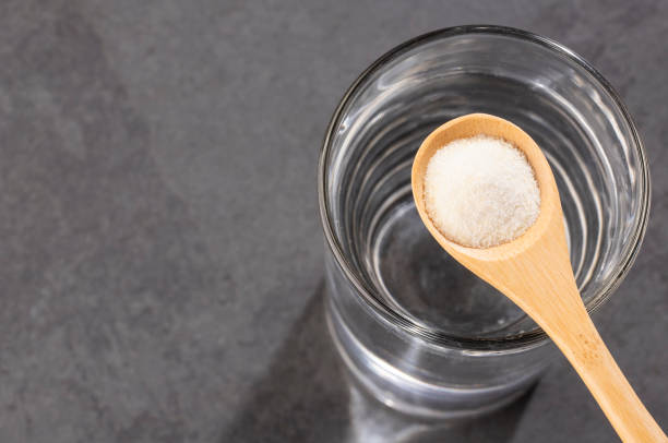 istock Powdered collagen protein. Glass of water 1148186551