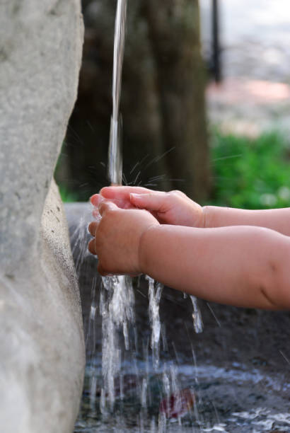 istock hands of a child under the water 1148188557