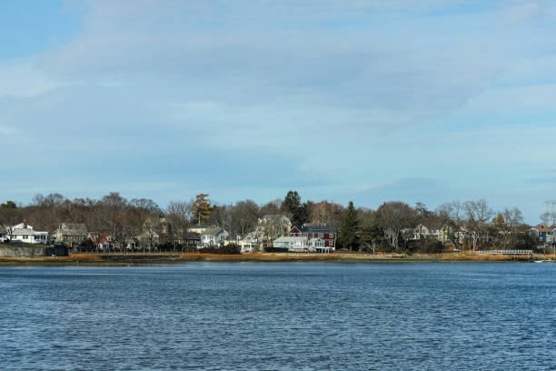 istock Calm bay water with houses in background 1148189584