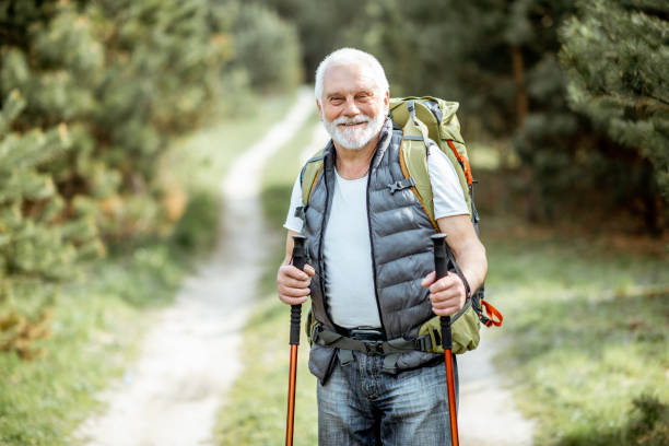 istock Senior man hiking in the woods 1148190772