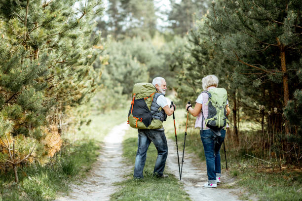 istock Senor couple hiking in the forest 1148190774