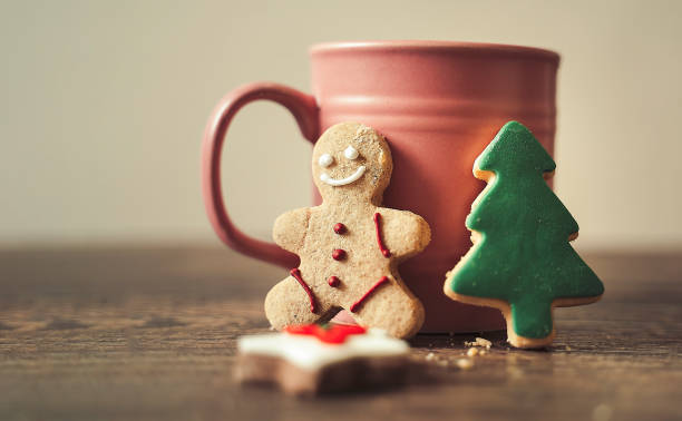 A cup of coffee on wooden table with cookies