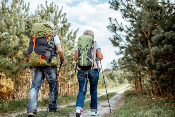 istock Senor couple hiking in the forest 1148190850