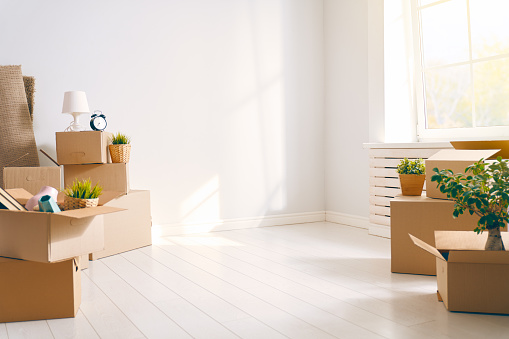 Cardboard boxes in empty new apartment.