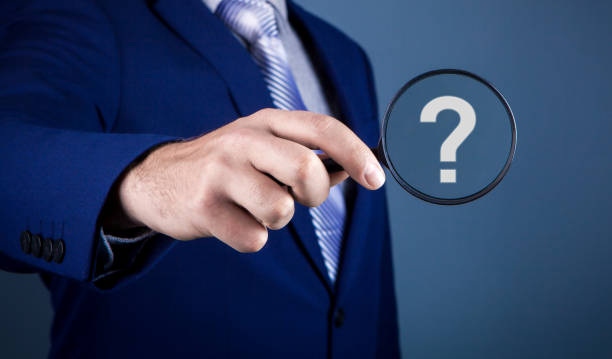 istock businessman magnifying glass question mark 1148193960