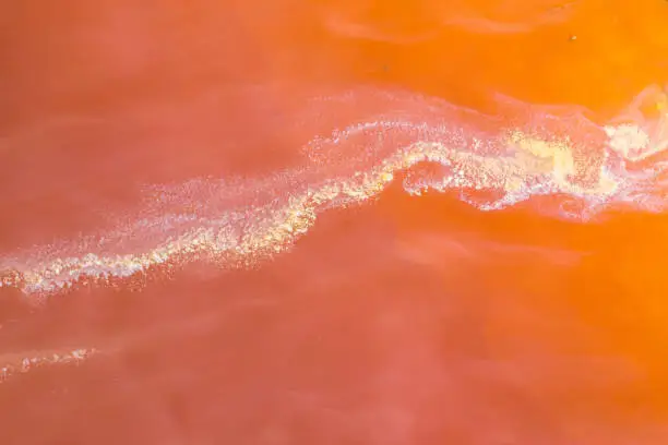 Abstract aerial background of red mining water from copper expoitation by drone