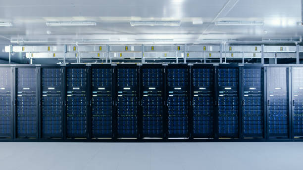 shot of a working data center with rows of rack servers. led lights blinking and computers are working. - network server rack computer mainframe imagens e fotografias de stock