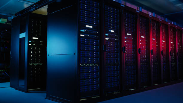 istock Shot of Data Center With Multiple Rows of Fully Operational Server Racks. Modern Telecommunications, Artificial Intelligence, Supercomputer Technology Concept. Shot in Dark with Neon Blue, Pink Lights 1148195844