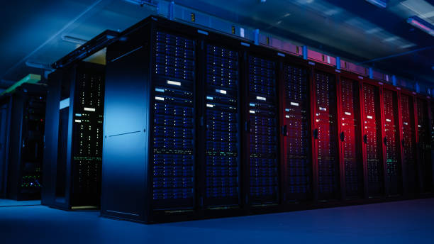 istock Shot of Data Center With Multiple Rows of Fully Operational Server Racks. Modern Telecommunications, Artificial Intelligence, Supercomputer Technology Concept. Shot in Dark with Neon Blue, Pink Lights 1148195851