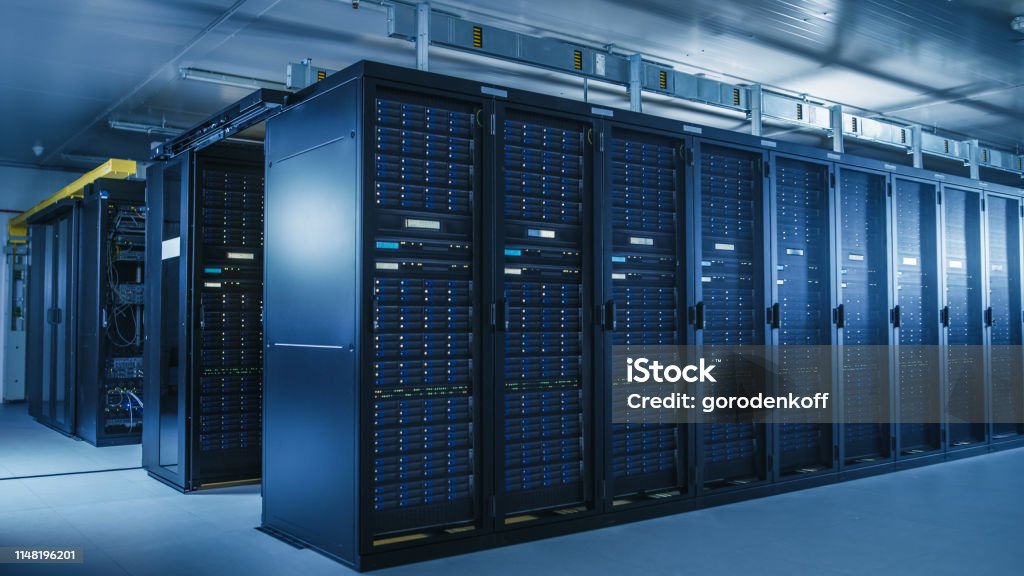 Shot of Modern Data Center With Multiple Rows of Operational Server Racks. Modern High-Tech Database Super Computer Clean Room. Data Center Stock Photo