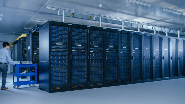 istock In the Modern Data Center: Team of IT Technicians Working with Server Racks, Running Maintenance and Diagnostics, Checking Networking and Cloud Computing Optimal Functioning. 1148196304