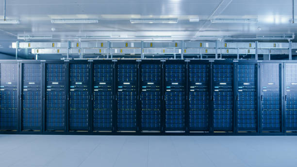 istock Shot of a Working Data Center With Rows of Rack Servers. Led Lights Blinking and Computers are Working. 1148196924