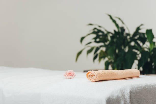 istock selective focus of massage table with rose and beige towel in spa 1148199984