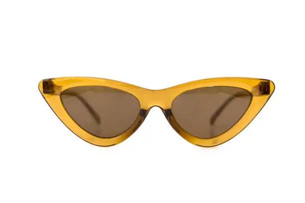 Yellow cat eye triangular thick frame sunglasses at isolated white background, front view