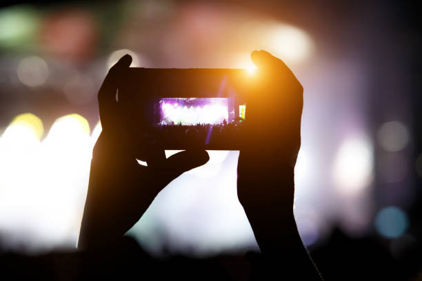 istock Smartphone in hand record outdoor music show 1148200364