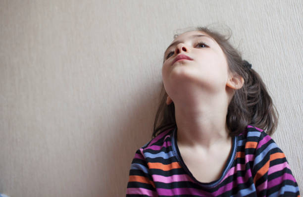 istock Little girl looking up 1148202764