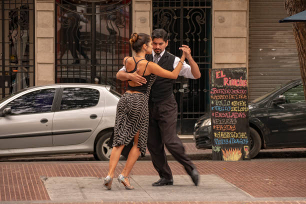 Tango dancers in the Plaza Dorredo in the historic center of San Telmo, Buenos Aires, Argentina It is common to find tango dancers in the Plaza Dorredo of the historic center of San Telmo, Buenos Aires, Argentina, who offer their art to tourists for tip. tango dance stock pictures, royalty-free photos & images