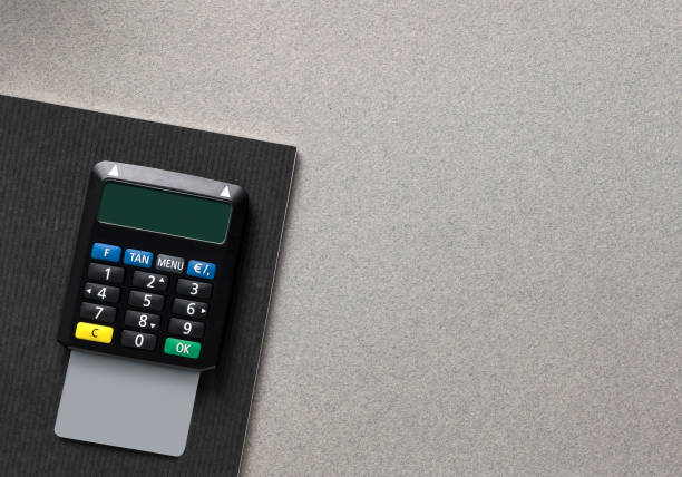 TAN Generator with empty debit card- credit card on gray office background with Notebook