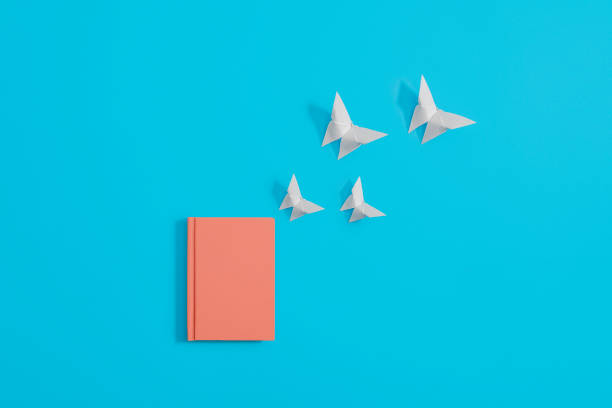 istock Orange notebook with origami butterflies 1148204444