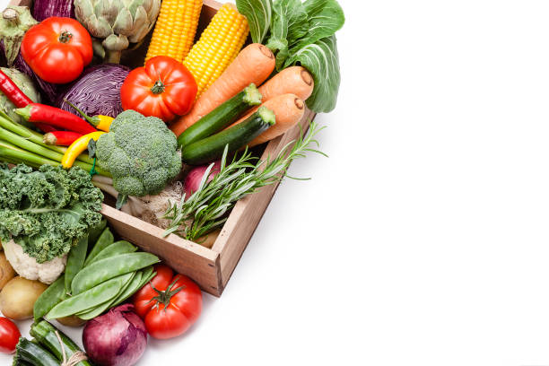 istock Healthy fresh vegetables in a wooden crate on white background with copy space 1148204549