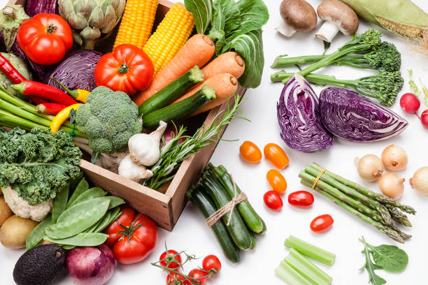 istock Healthy fresh vegetables in a wooden crate on white background 1148204552