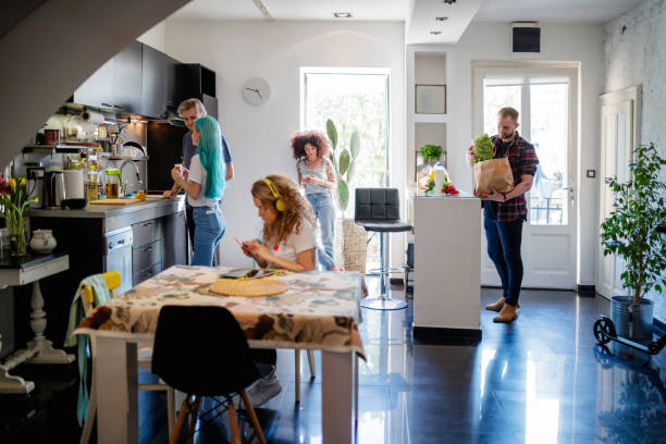 istock Group of young flatmates in the kitchen, sharing living space 1148205209