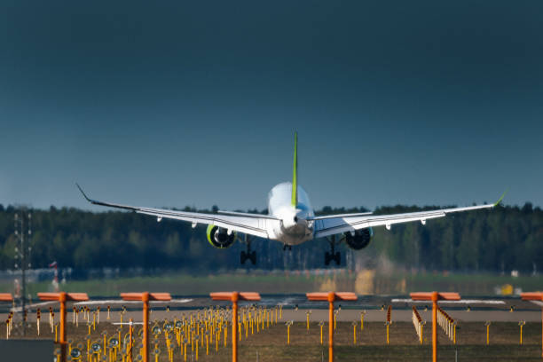 Airplane is landing to runway Airplane is landing to runway upward mobility stock pictures, royalty-free photos & images