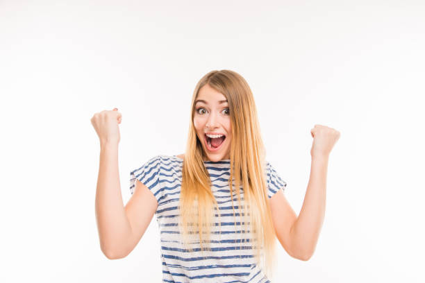 istock Happy surprised girl with raised fists 1148208089