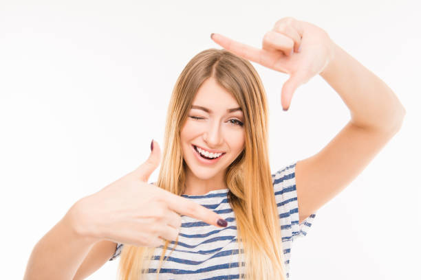 istock Cheerful young woman gesturing finger frame and smiling 1148208102