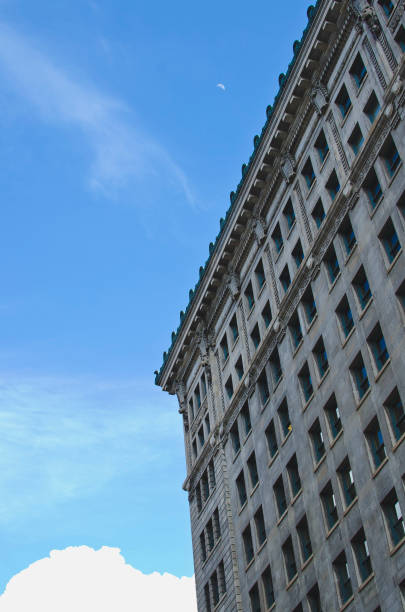 istock Looking up at the moon in the city 1148208155