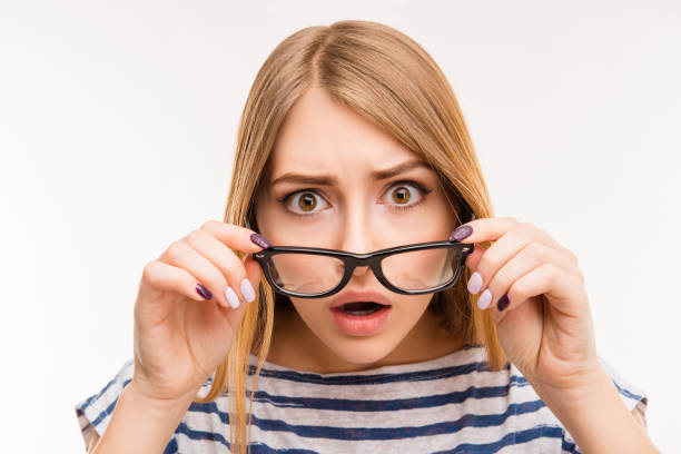 istock Surprised girl taking off her glasses 1148208288