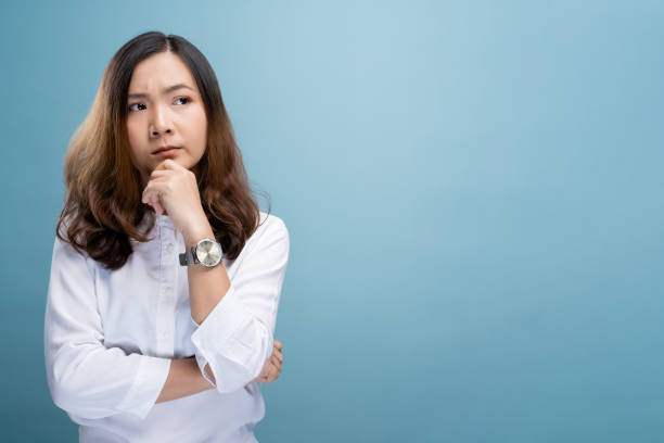 istock Angry woman standing isolated over blue background 1148208629