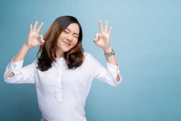 Happy woman showing OK gesture isolated on background