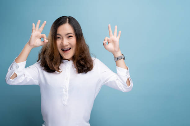 istock Happy woman showing OK gesture isolated on background 1148208634