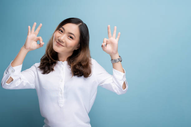 istock Happy woman showing OK gesture isolated on background 1148208636