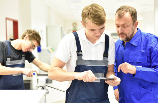 Group of young people in technical vocational training with teacher