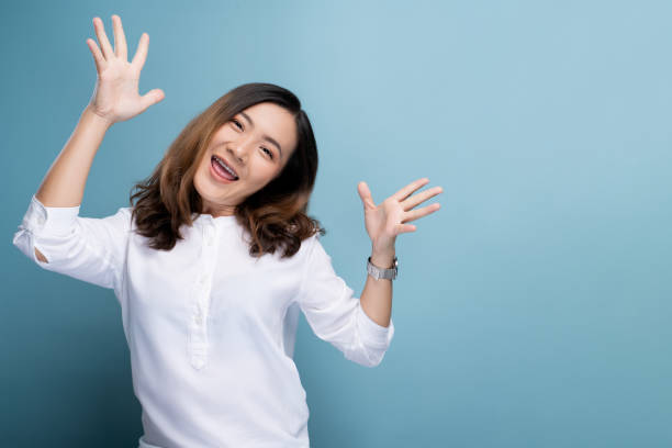 istock Happy woman make winning gesture isolated over blue background 1148208702