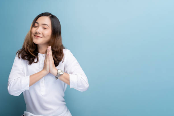 istock Happy woman thinking and standing isolated over blue background 1148208743
