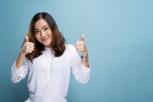 istock Happy woman showing thumb up isolated on background 1148208822