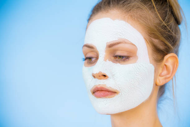 istock Girl with dry white mud mask on face 1148208845