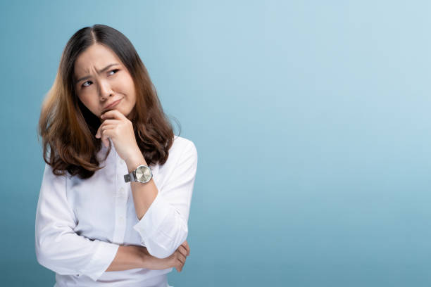 istock Woman feel confused isolated over blue background 1148208853