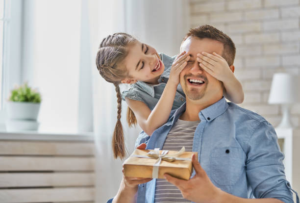 daughter congratulating dad Happy father's day! Child daughter congratulating dad and giving him gift box. Daddy and girl smiling and hugging. Family holiday and togetherness. fathers day fathers love day stock pictures, royalty-free photos & images